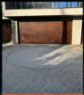 Exposed aggregate driveway with a circular vehicle turntable