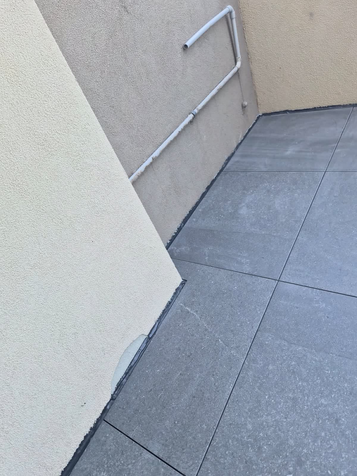Corner of the tiled balcony against the wall