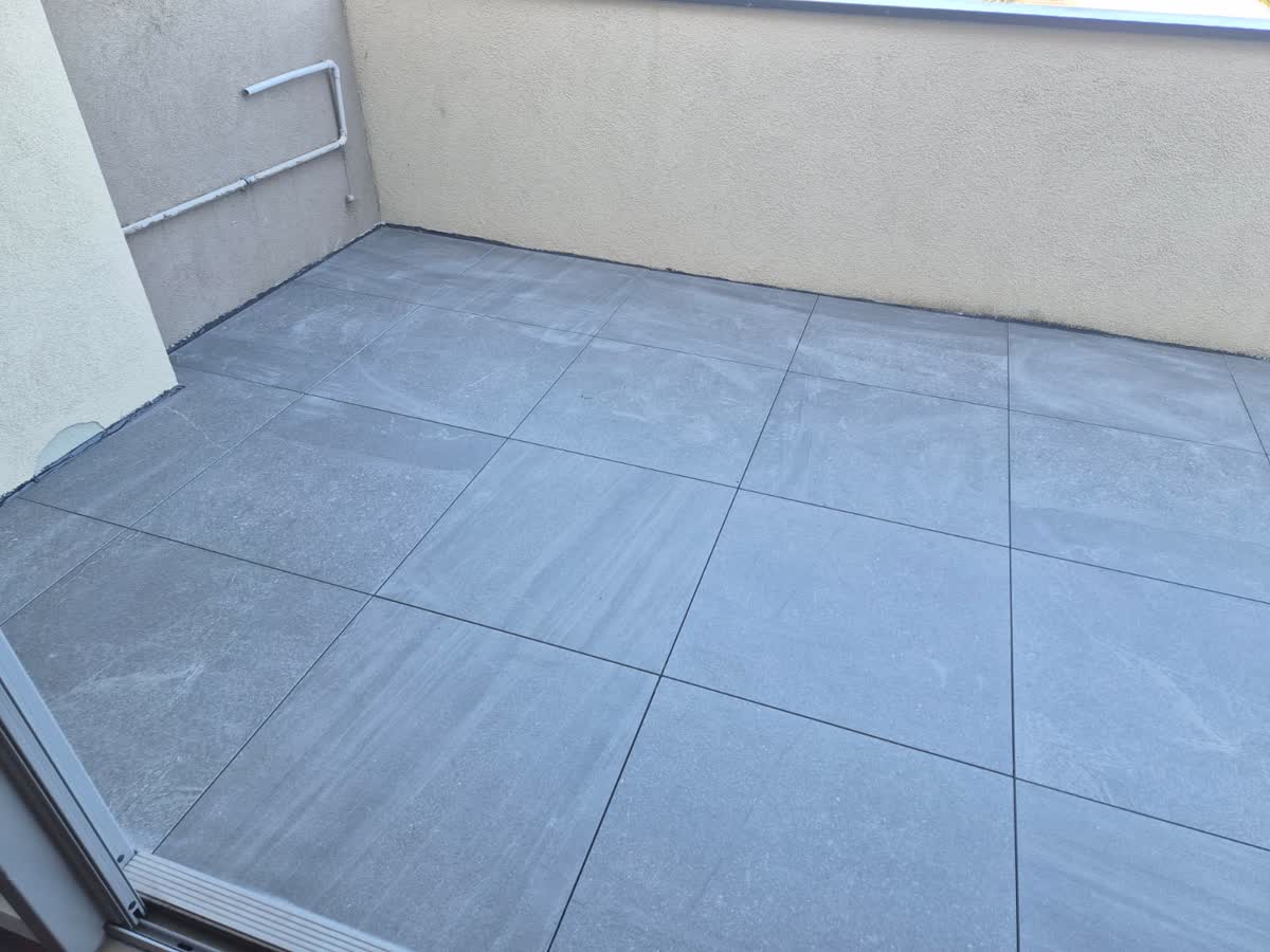 Finished balcony with large grey tiles