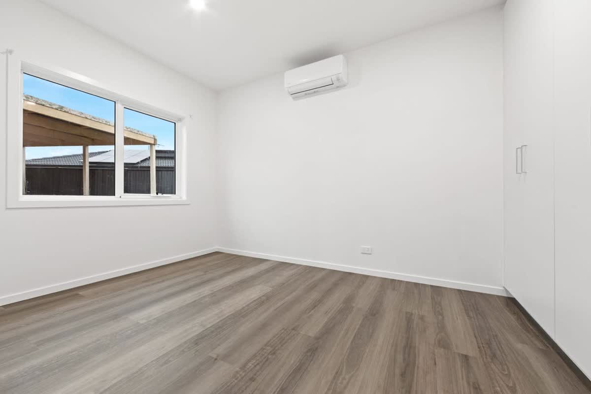 Bedroom with timber-look floor, a window and a split system
