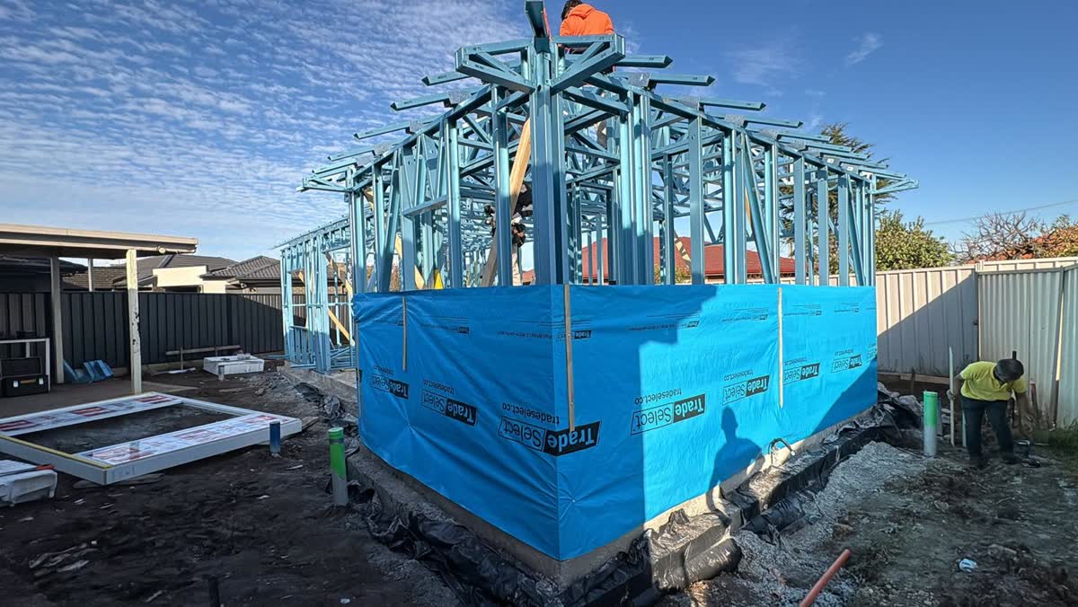 Blue steel wall frames and roof trusses on the slab