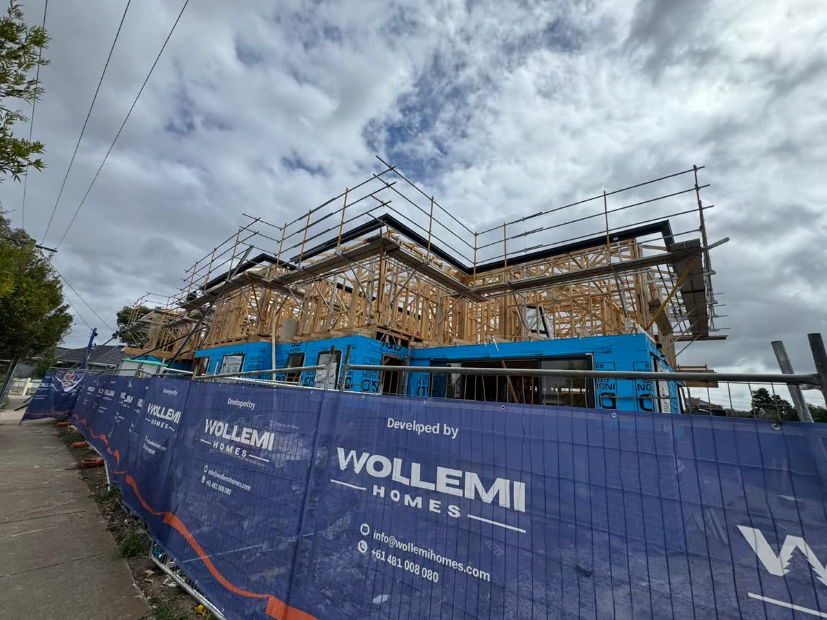 Double-storey timber frames with scaffold, behind Wollemi site fencing